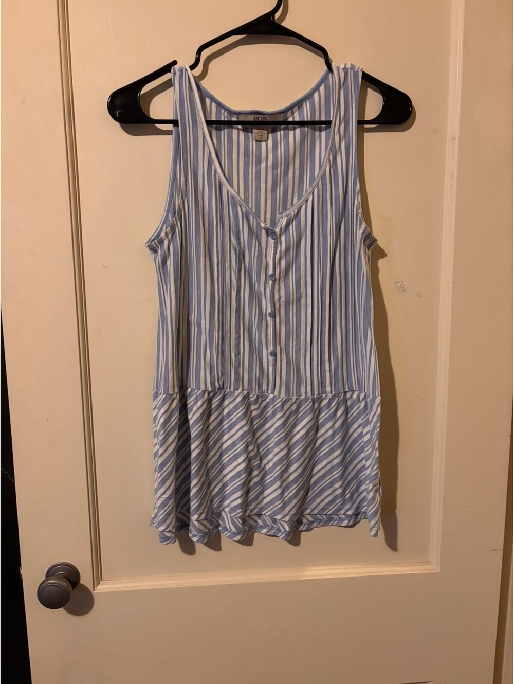 Blue and white striped sleeveless peplum top Medium